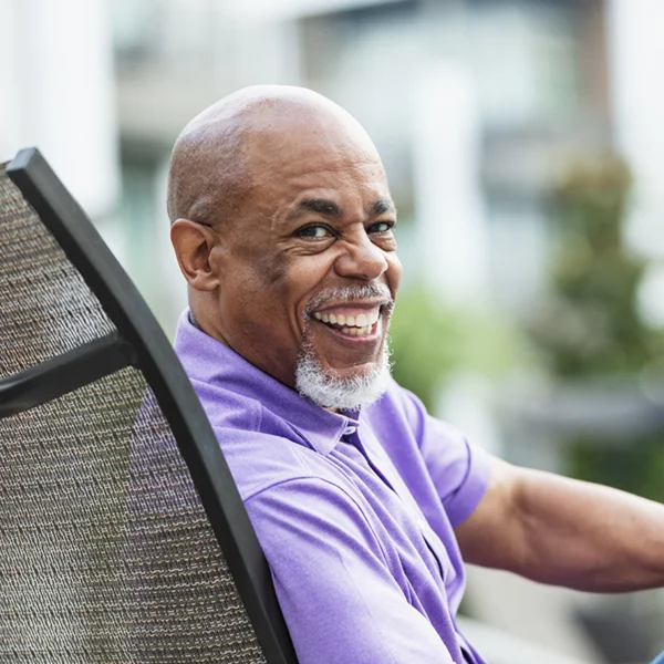 senior man overlooking his shoulder and smiling