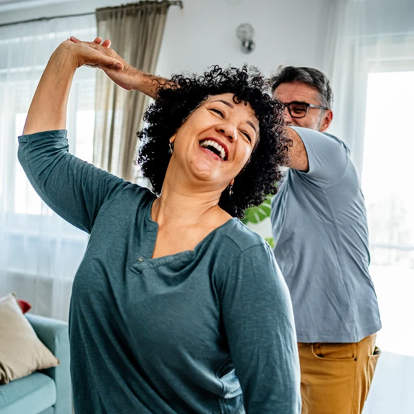 older couple dancing in living room