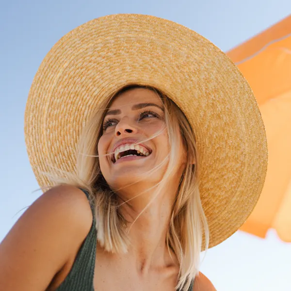 adult woman in a straw sunhat smiling