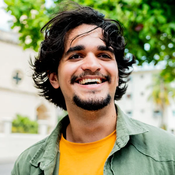 young adult male smiling outdoors