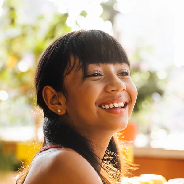 young girl outdoors smiling