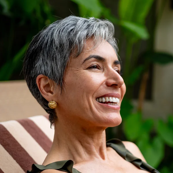 senior woman relaxing on an outdoor chair smiling