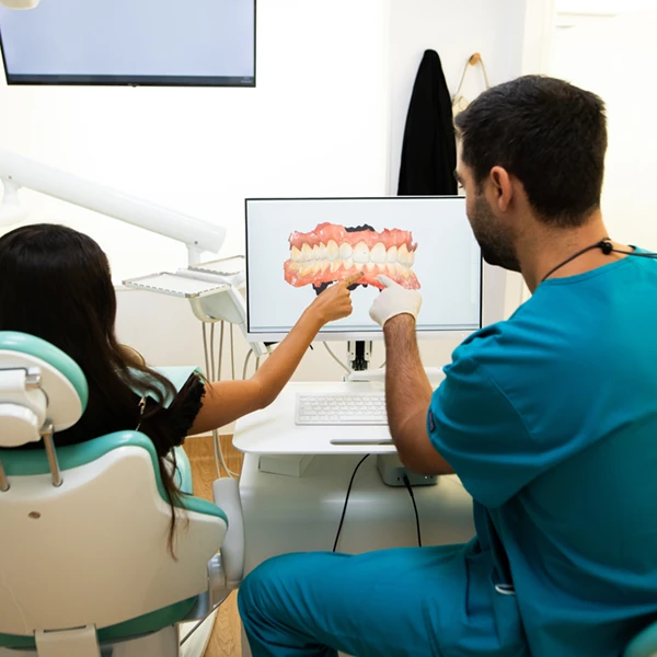 surgeon showing 3D mouth scan to child patient