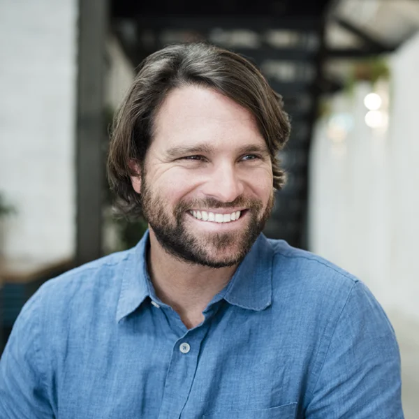 mid adult man in blue denim shirt smiling